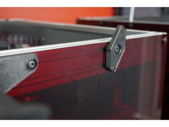 On the right side of the printer, locate the fourth bolt across the top edge from the front that holds the acrylic to the aluminum.