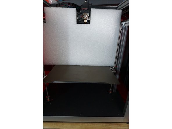 Slide the bottom white box from under the bed and set it to the side.