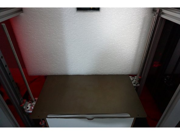 Slide the bottom white box from under the bed and set it to the side.