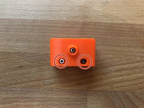 Loosely fit 2 x M3 12mm screw into the holes on the side