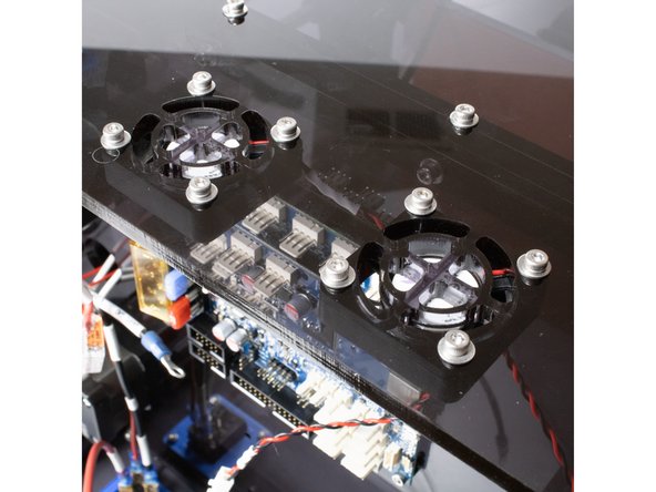 Using (4) M3 x 20 socket head screws, M3 washers, and M3 nuts, install the (2) panel fans under the rear panel.