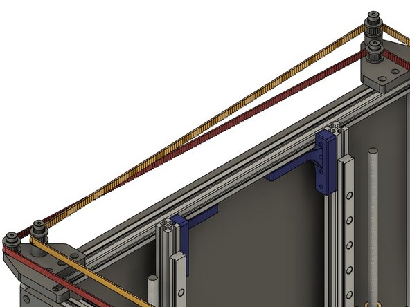 The belt crosses the left side of the printer, to the toothed idler on the tall stack of the rear idler mount.
