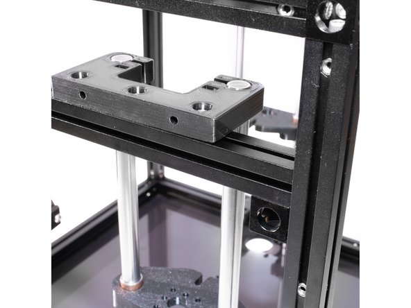 Using (3) M3 x 10 socket head screws for each tower, fasten the Z rod holders to the brace using the M3 nuts in the top channel of the extrusion.