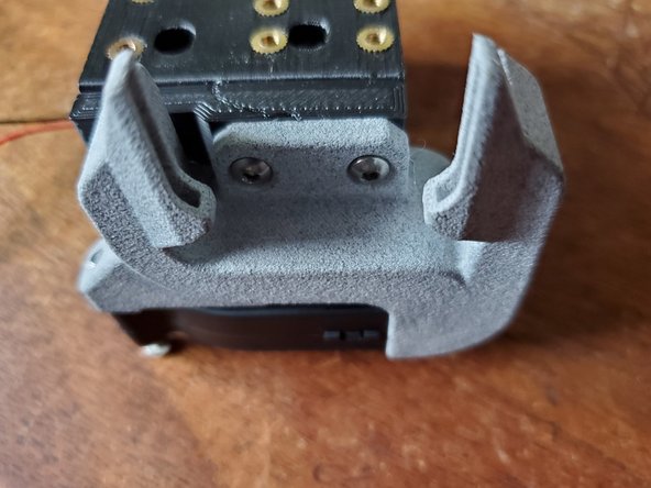 Start by attaching the Layer fan and shroud. Attach the Layer fan to the bottom of the adapter using one m3x8mm Button head bolt into the rear hole (the one going to the m3 washer) and one m3 x 12mm Button head bolt that will pass through the other hole and into the brass insert in the Y carriage.