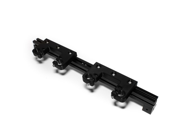 Mount (2) Z rod holders to the right extrusion by sliding the M3 nuts into the top channel. Place (2) M3 nuts into the channel between the (2) rod holders. Tighten the Z rod holders to the extrusion just enough to keep them from moving freely.