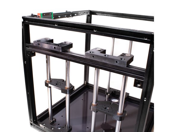 Using (3) M3 x 10 socket head screws for each tower, fasten the Z rod holders to the braces using the M3 nuts in the top channel of the extrusion.