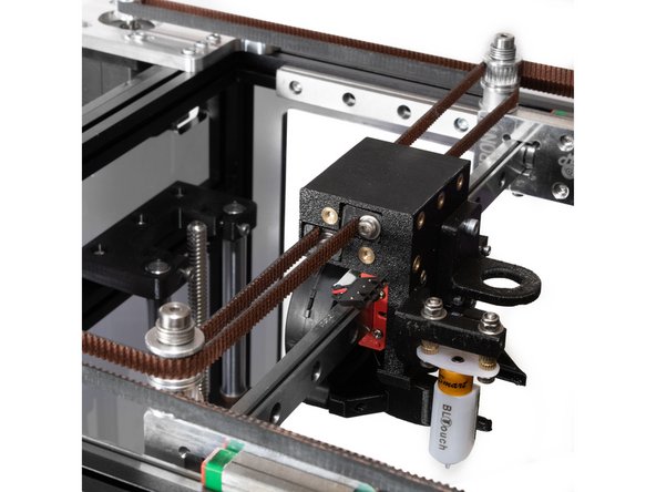 The belt wraps around the rear stepper pulley, and goes back to the rear X carriage, with the back of the belt against the smooth idler at the top of the rear X carriage idler stack.