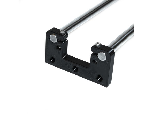 Using (2) M3 nuts and (2) M3 x 20 socket head screws, tighten a Z rod holder to the smooth rods. The rod top of the Z rod holder should be flush with the top of the smooth rods.