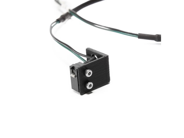 Attach the X endstop (it comes pre-wired) to the printed X endstop mount using (2) M2 x 12 socket head screws and (2) M2 Nuts