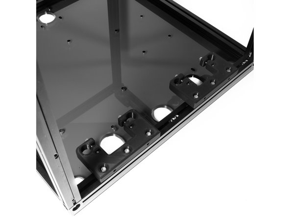 On the right side of the frame, attach (2) Z rod holders to the bottom right extrusion using (6) M3 x 10 socket head screws.  Leave 2 M3 nuts between the rod holder and another two after the rod holder towards the back extrusion as pictured.