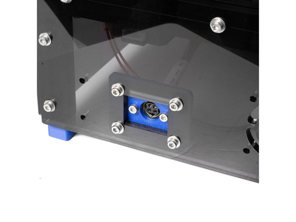 Using (2) M3 x 10 self tapping screws, attach the power plug to the printed mount.