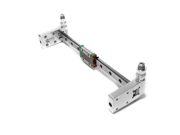 There is a round metal spacer that goes between the Y rail and the horizontal part of the carriage. Lightly tighten the horizontal M3 bolt to hold it in place.
