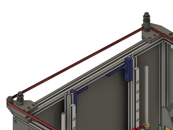 The belt should cross to the left of the printer, and the teeth should engage the toothed idler on the shorter, inside shoulder bolt on the rear idler mount.