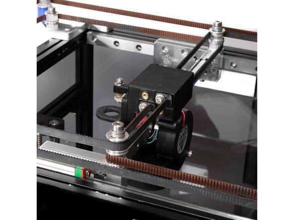 To install the rear or &quot;X&quot; belt, start by installing a belt clip on the end of the belt, and insert it into the top hole on the front of the Y carriage.