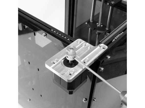 Install one of the 16t pulleys onto the stepper shaft with the teeth facing up. There are two set screws, be sure one of them is against the flat of the stepper shaft.