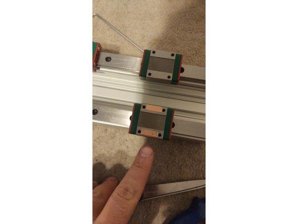 Start by identifying if there's a height difference between carriage blocks on opposite sides of the C-Beam. If one side is lower, you will need to equalize the height by placing one or more layers of shim tape on that side. The shim tape will be sandwiched between the carriage block and the plate.