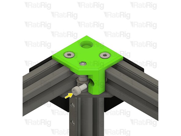 Place the 3030 T-nut into the extrusion channel and slide it under the CoreXY idler as shown. Position the T-nut so that you are able to see it though the marked hole