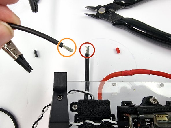 Cut the supplied spade connector off the black wire from the thruster ESC and strip the insulation from the end of the wire.