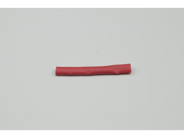 Cut and slide a 60mm length of heat shrink over the red fuse wire.