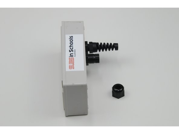 Loosely screw the stress relief (short) onto the larger threads.