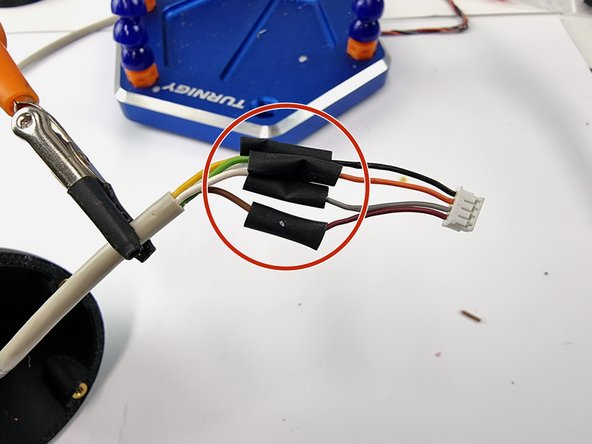 Slide the heat shrink over the soldered joints.