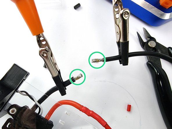 Grab the 16Awg black wire supplied in the kit and strip the insulation from the end of the wire.