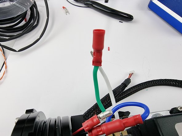 Slide a female crimp connector onto the green wire and crimp into place.