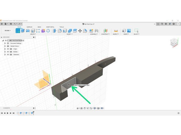 Create a new sketch on the inner planar face of the wheel well recess.