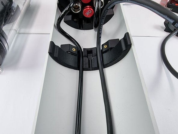 Straighten the cable out and insert it into the slot in the hull support.