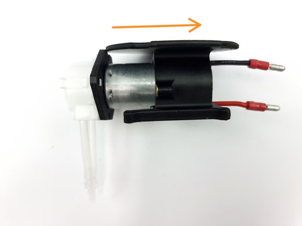 Feed the wires into the hole of the mount and slide the pump into the mount.