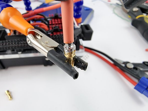Fill the cavity in the pin with solder to secure and create a good connection with the wire