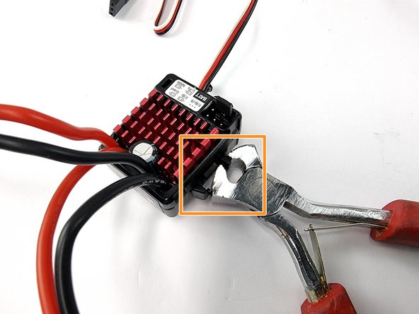 Using a pair of pliers or side cutters grab one of the pieces of plastic to be removed and twist it to one side to break it away from the ESC