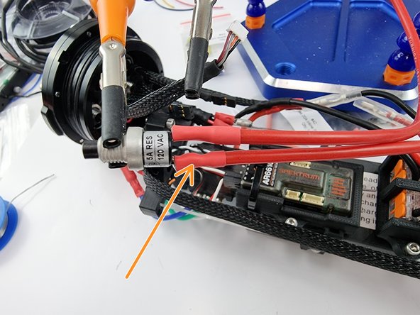Allow the solder to cool and then slide the heat shrink over the joint and apply heat to shrink the heat shrink into place.
