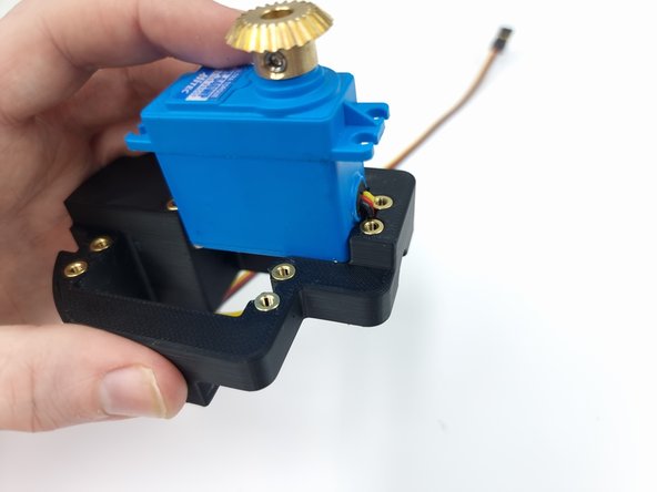 Insert the first servo into the Aft Servo mount, make sure you feed the wire through first.