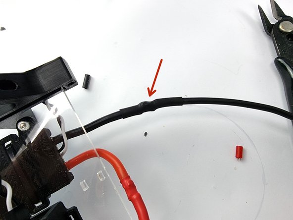 Slide the heat shrink over the soldered joint and heat to shrink it into place.