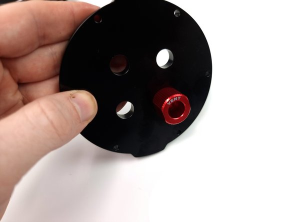 Insert and fit the bolt of the vent to the cap and tighten the nut on the back