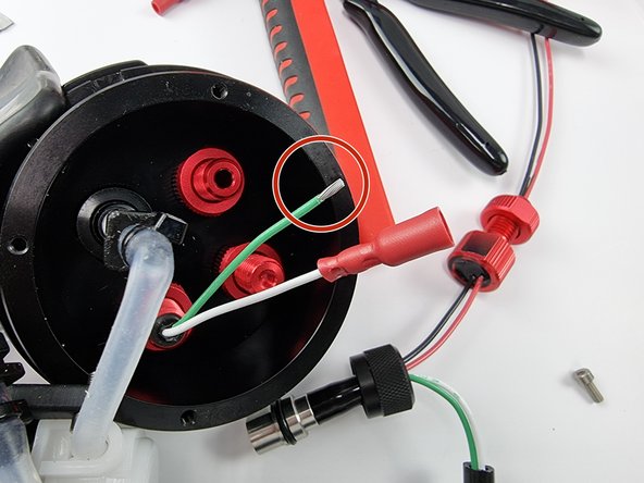 Trim the green wire to length and strip the insulation from the end of the wire.