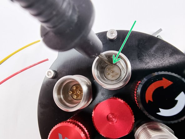 Touch one probe on one of the pins in the black connector that plugs into the receiver.