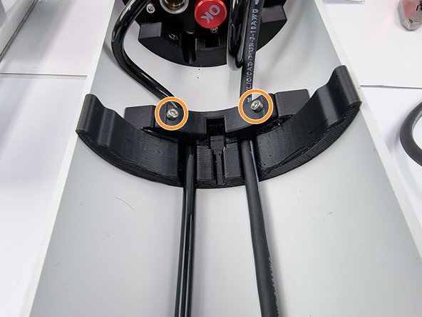 Insert 2 x 8mm socket head cap screws to fix the cable cover in place.