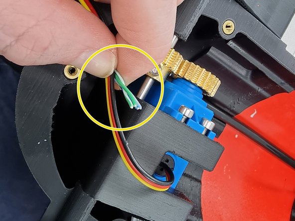 Position the wires to work out the postion to trim the wires from the servo to prepare to join them together.