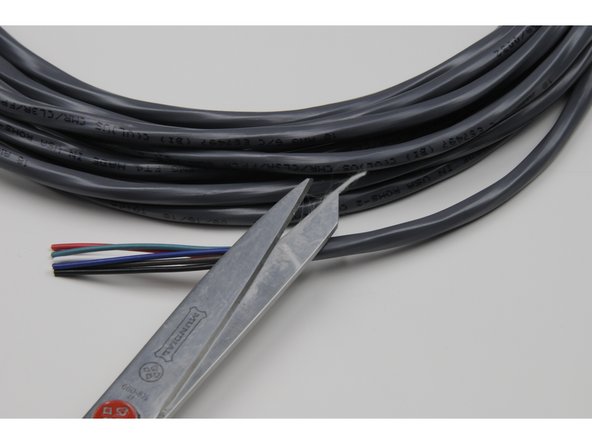 Cut the string inside, but make sure all six coloured wires are still intact.