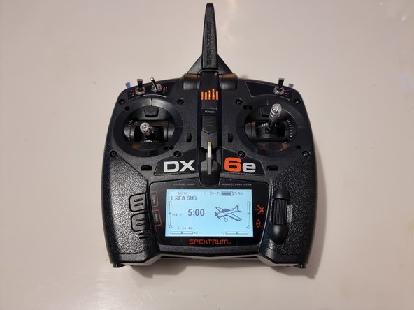 By default the throttle is the left joystick. If turning it down doesn't remove the warning try the other joystick.