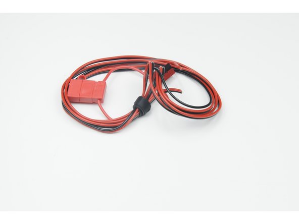 Using your wire strippers, strip 15mm from the ends of the red fuse wire and the red power wire.