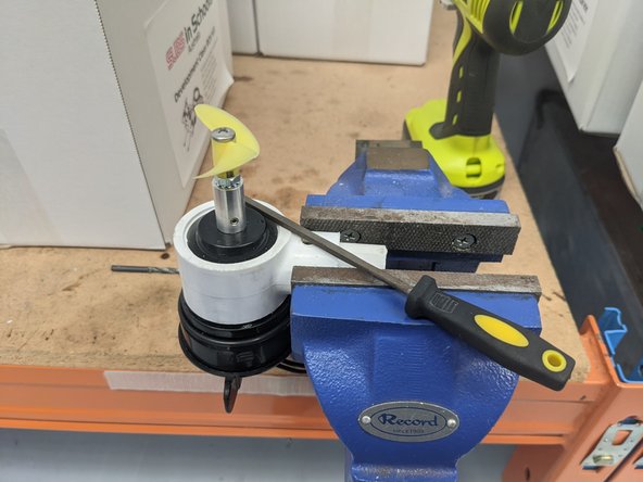 Use a small hand file to clean up any PVC shavings or sharp edges from the hole.