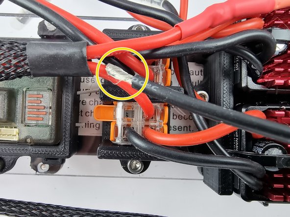 Strip the insulation from the end of the wire and twist the strands to prepare them to be inserted into the Wago 221 terminal block.