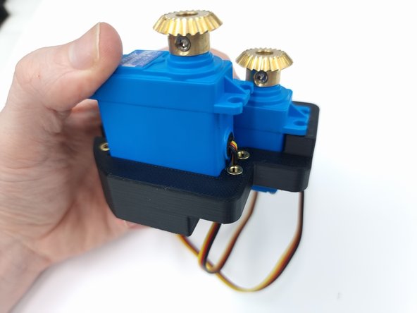 Insert the second servo into the mount again ensuring to feed the wore through first.