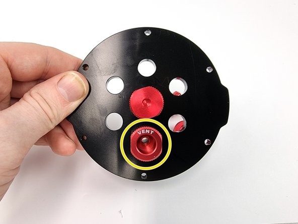 Insert the vent penetrator into the bottom hole of the end cap