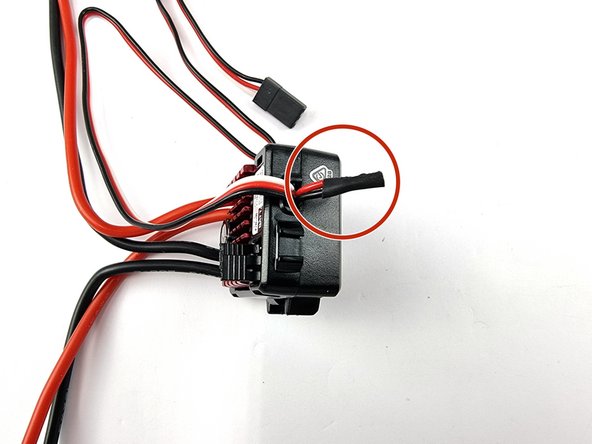 With the 2 wires soldered together. Add a piece of heat shrink to cover the exposed wire and heat it up to shrink into onto the wires