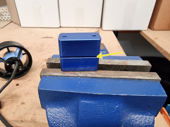 Using a drill press or a soft hammer, push down or gently tap on the upper half of the Termination Tool until the Connector Insert is pressed completely into the Connector Shell.