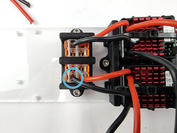 Insert the positive wire into the connector that has the positive wire from the first ESC and close the lever to lock it into place